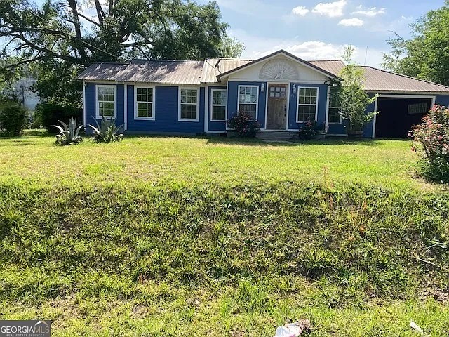 So Much Potential! Spacious Small-Town Home With a Huge Yard and Newer Metal Roof!