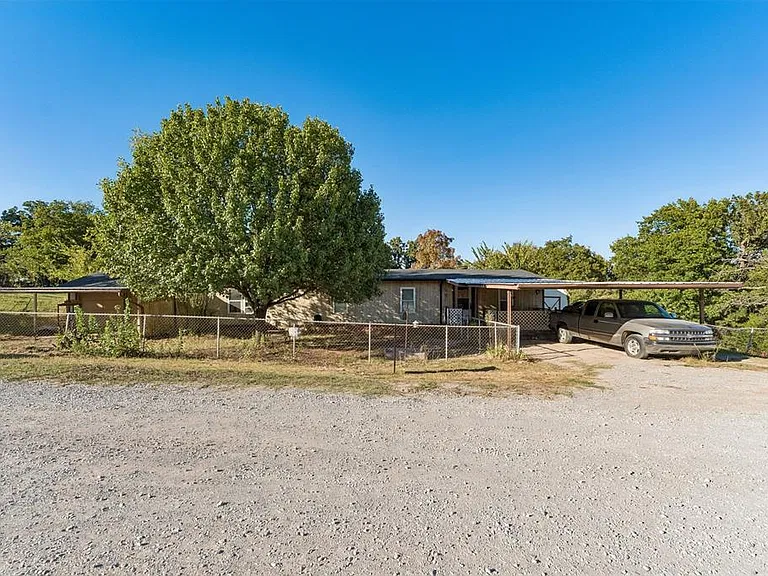 Oklahoma Wooded Retreat for $90,000 on 1.25 Acres With 3 Bedrooms, a Stone Fireplace, and a 2-Car Garage