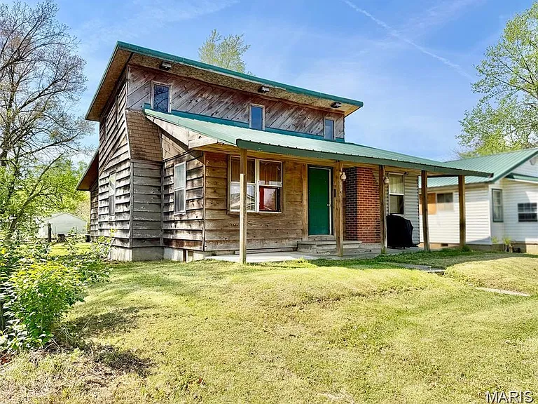 Missouri Fixer-Upper With 4 Bedrooms, a Rustic Stone Fireplace & a Covered Front Porch