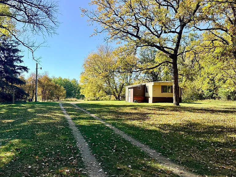Minnesota Country Retreat for $99,000 With 11 Acres of Mature Trees & a Cozy 2-Bedroom Home